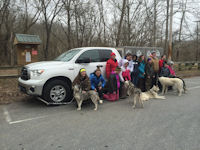 A Girl Scout troop poses with the sled dogs after their program.