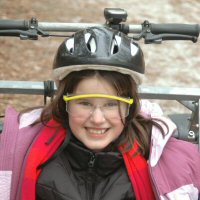 One of our young Girl Scouts poses before her dryland dog sledding adventure.