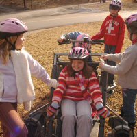 The Girl Scouts play on their wheeled chariot.