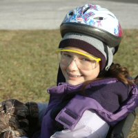 A young girl scout before dryland dog sledding