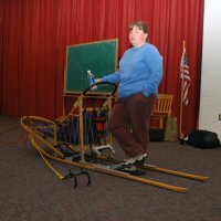 Catherine stands at the helm of her sled